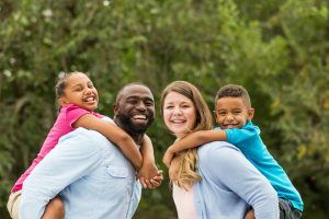 Multiracial Happy Family of two parents and two children smiling